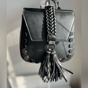 LIONEL FAUX LEATHER BRAIDED AND TASSELL STUDDED CROSSBODY BACK PACK STRAP BAG